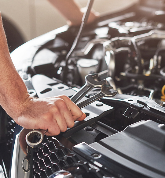Professional mechanic working on car